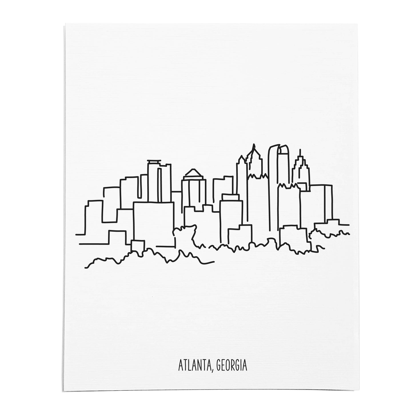 An art print featuring a line drawing of the Atlanta Skyline on white linen paper