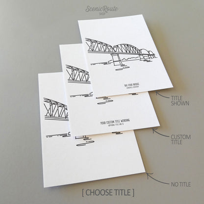 Three line art drawings of the Big Four Bridge in Louisville Kentucky on white linen paper with a gray background.  The pieces are shown with title options that can be chosen and personalized.