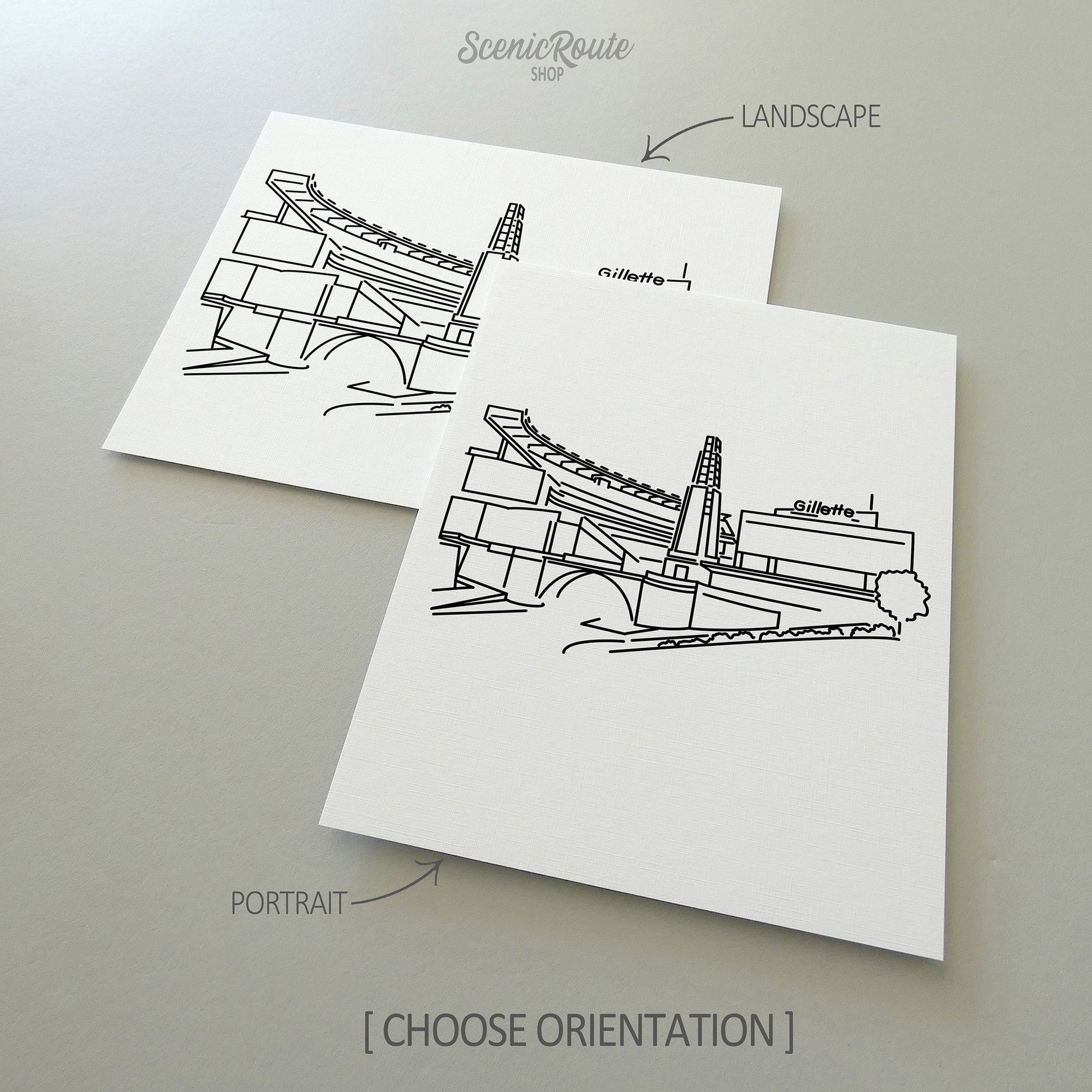 Two line art drawings of the Patriots Stadium on white linen paper with a gray background.  The pieces are shown in portrait and landscape orientation for the available art print options.