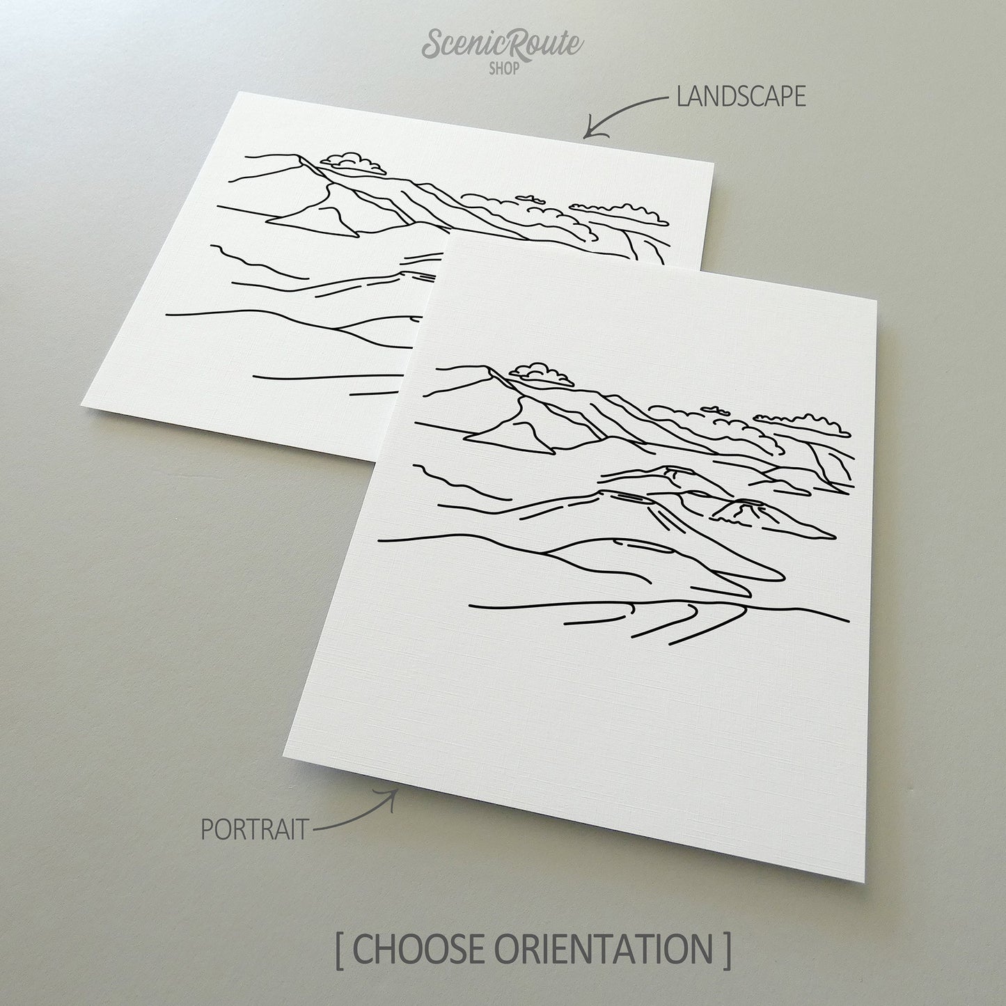 Two line art drawings of Haleakala National Park on white linen paper with a gray background.  The pieces are shown in portrait and landscape orientation for the available art print options.