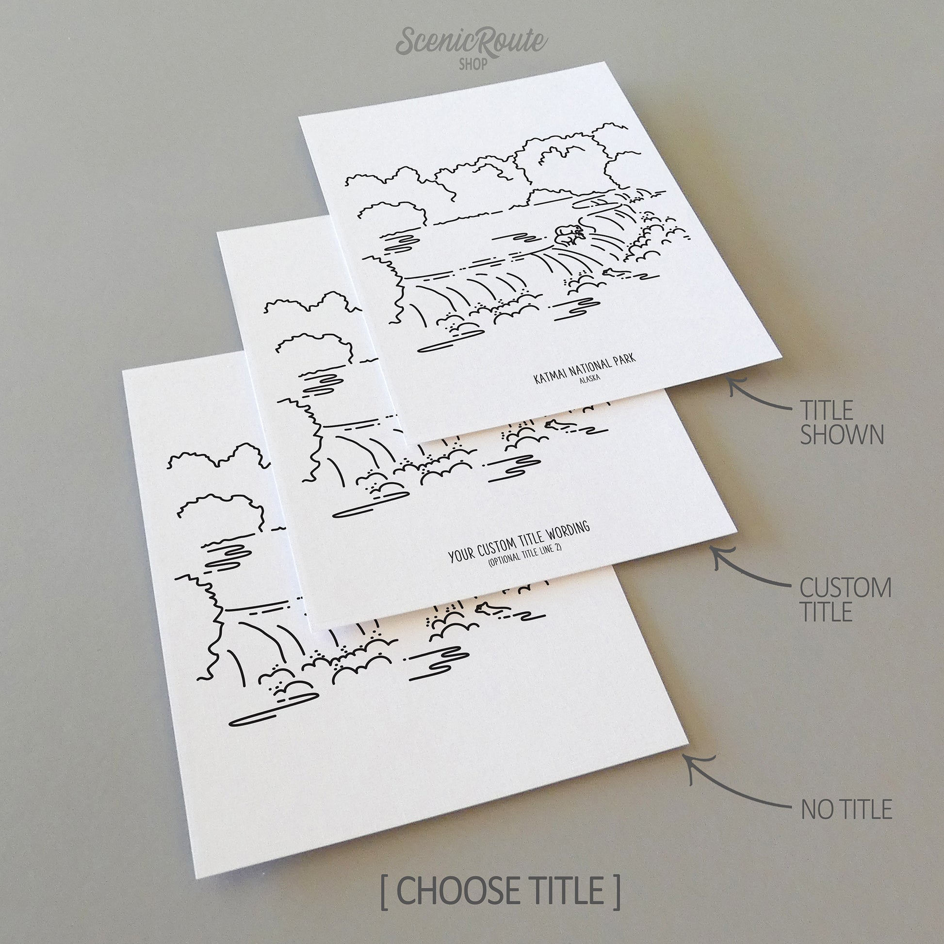 Three line art drawings of Katmai National Park on white linen paper with a gray background. The pieces are shown with title options that can be chosen and personalized.