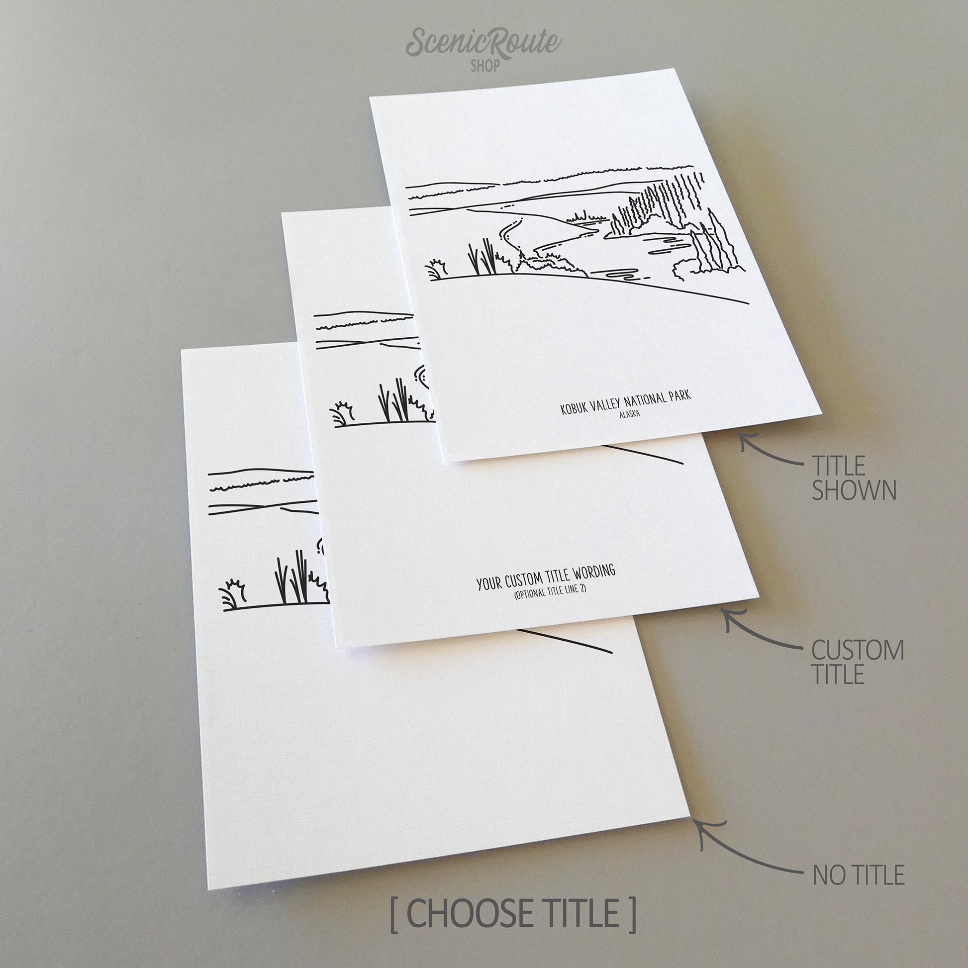 Three line art drawings of Kobuk Valley National Park on white linen paper with a gray background. The pieces are shown with title options that can be chosen and personalized.