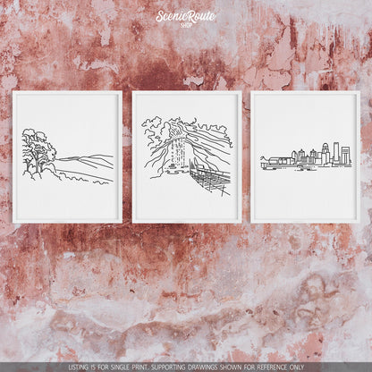 A group of three framed drawings on a concrete wall. The line art drawings include Shenandoah National Park, Mammoth Cave National Park, and the Louisville Skyline