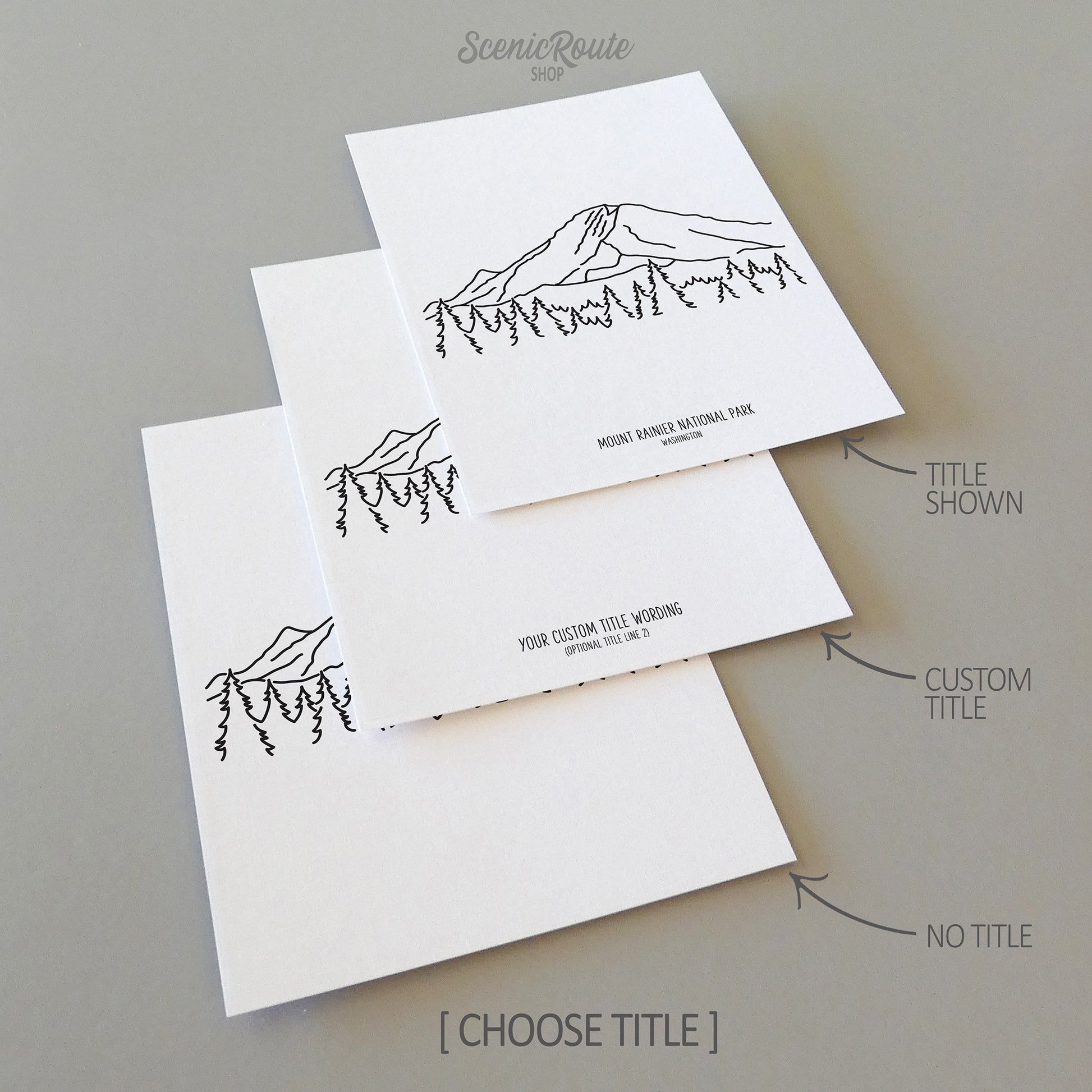 Three line art drawings of Mount Rainier National Park on white linen paper with a gray background. The pieces are shown with title options that can be chosen and personalized.