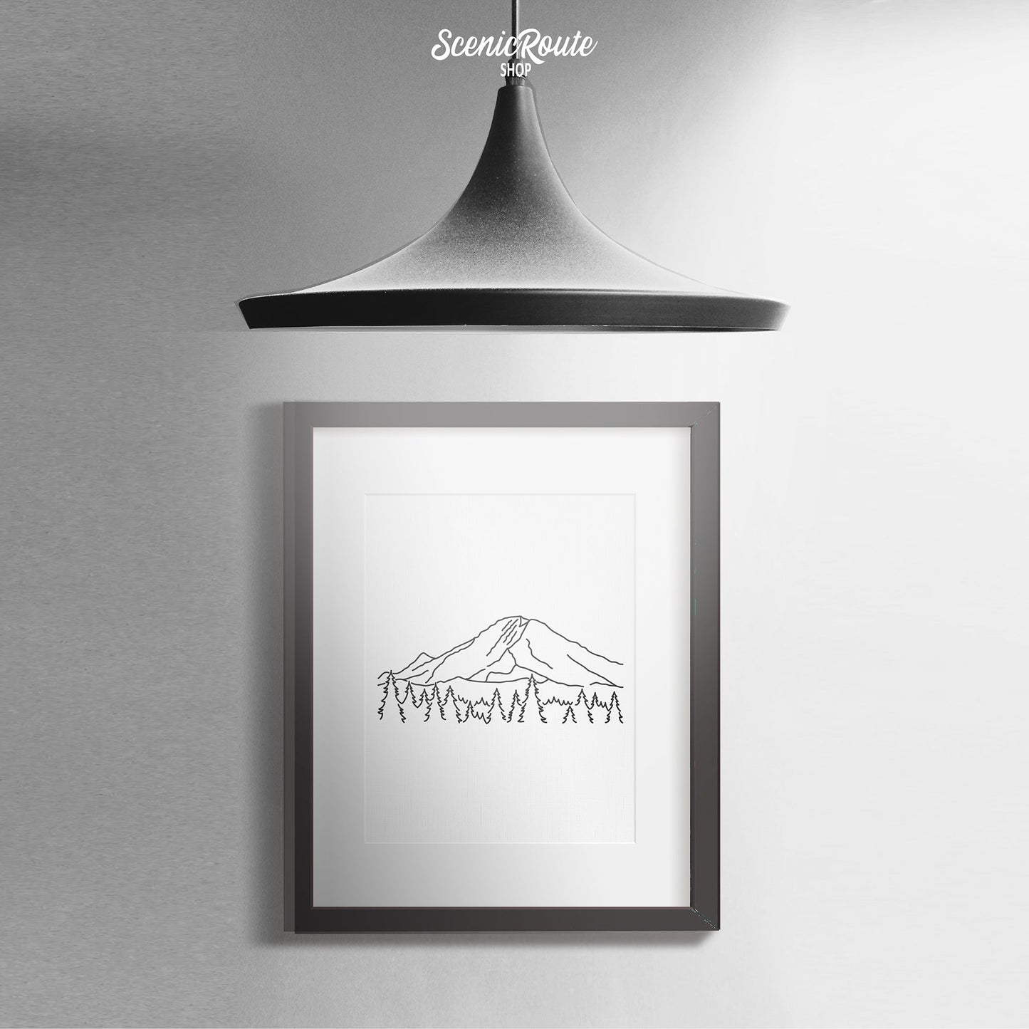 A framed line art drawing of Mount Rainier National Park with a pendant lamp